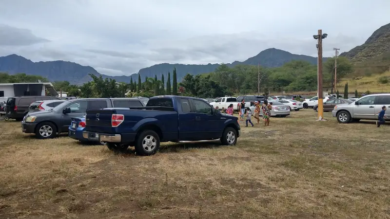 Kids walking across the parking field with the mountains behind